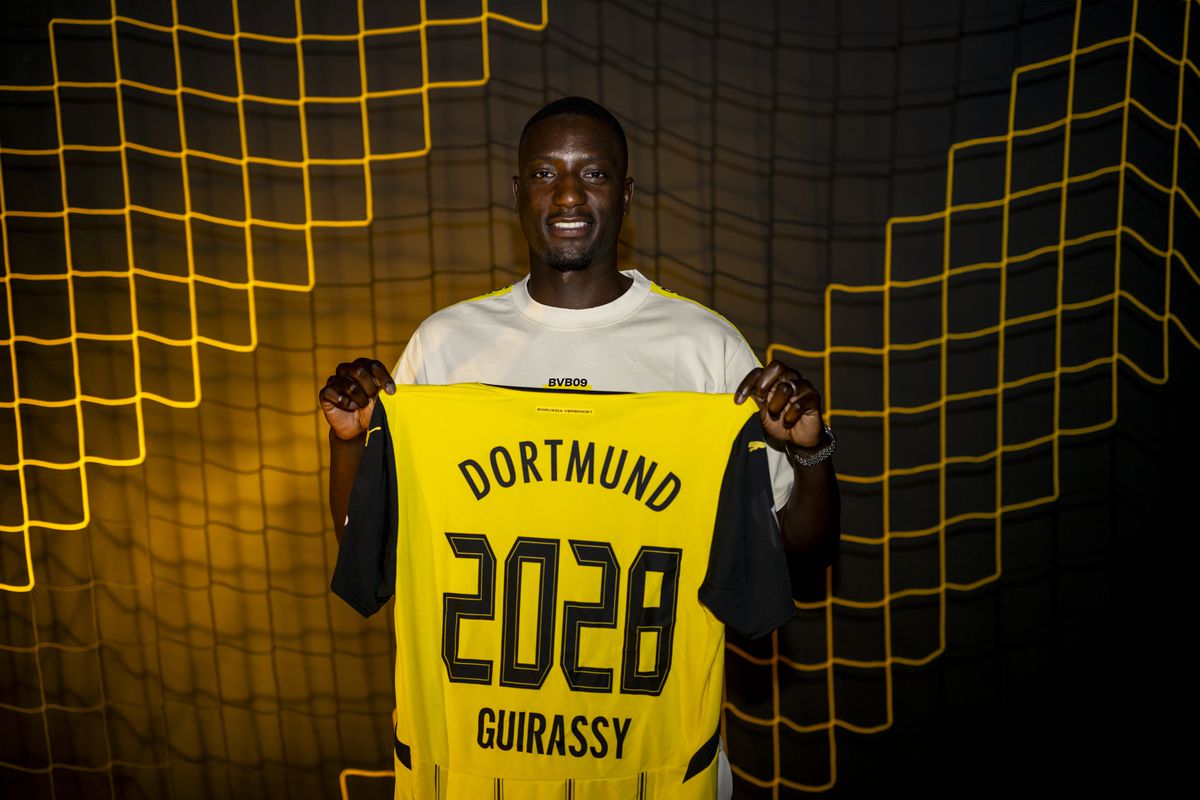 Guirassy posing with the dortmund kit. Image Credit: Dortmund Image